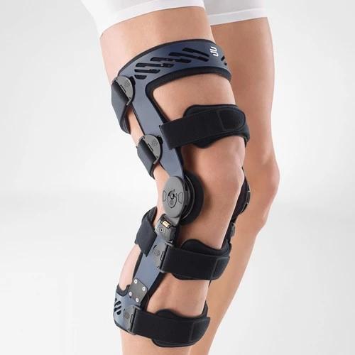 Knee brace in a colour combination of blue and black and is worn on the right knee. It is considered one of Bauerfeind Australia's best recovery knee braces, Secutec OA.